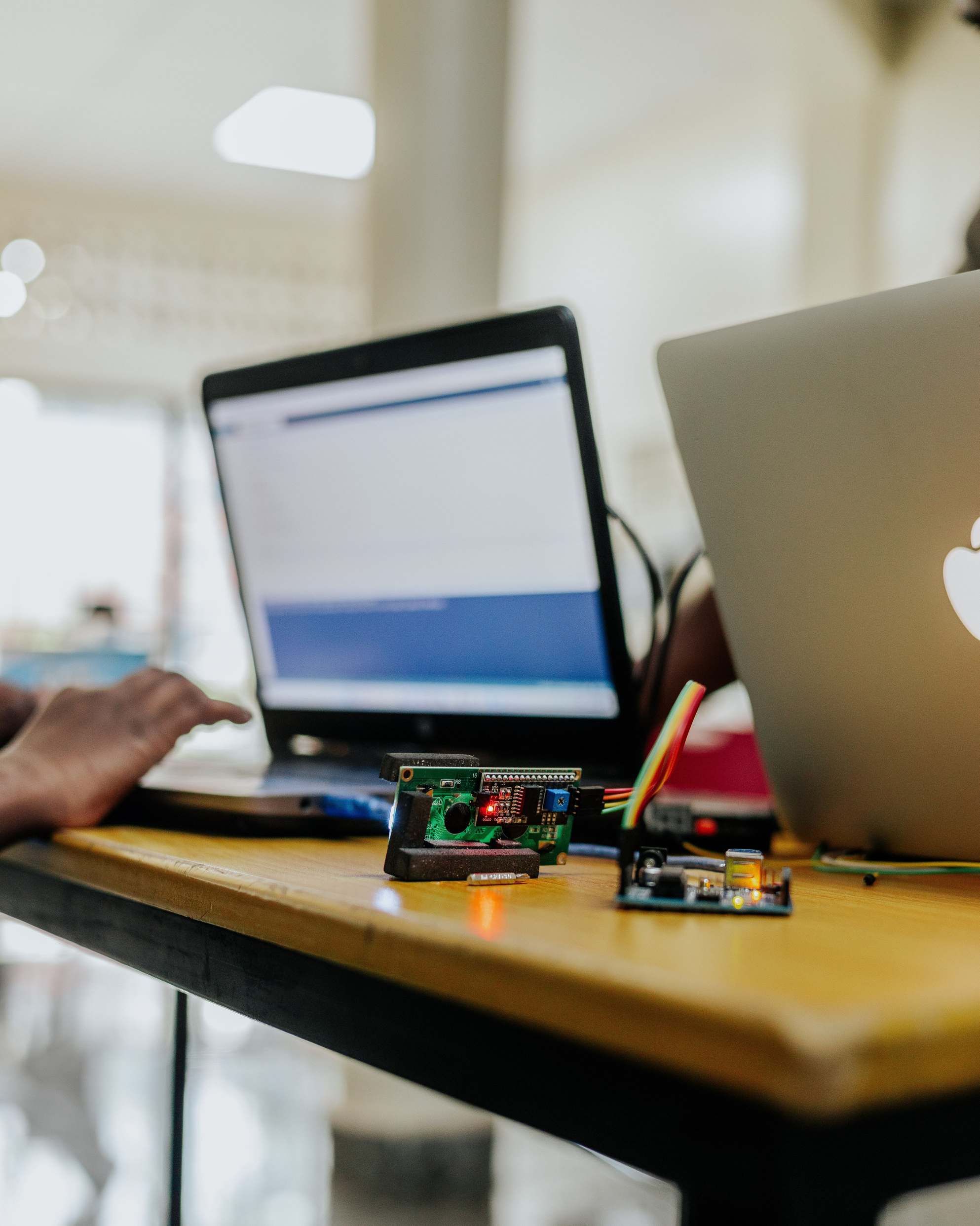 Laptop and keyboard on a desk for software development work, electronics and laptops on a workspace table indoors